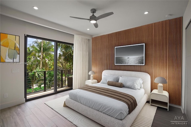 bedroom featuring an accent wall, recessed lighting, access to outside, and baseboards