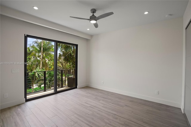 spare room featuring recessed lighting, ceiling fan, wood finished floors, and baseboards