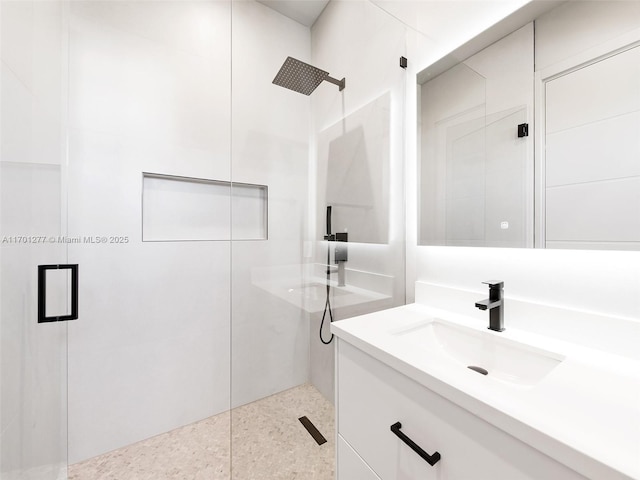 full bathroom with vanity and a shower with door