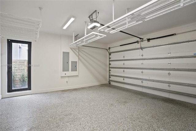 garage with electric panel and baseboards