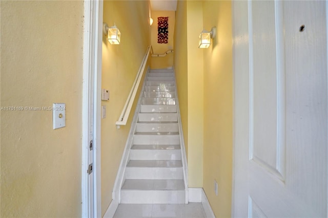 stairs featuring tile patterned floors