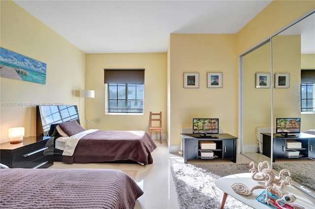 bedroom featuring multiple windows and a closet