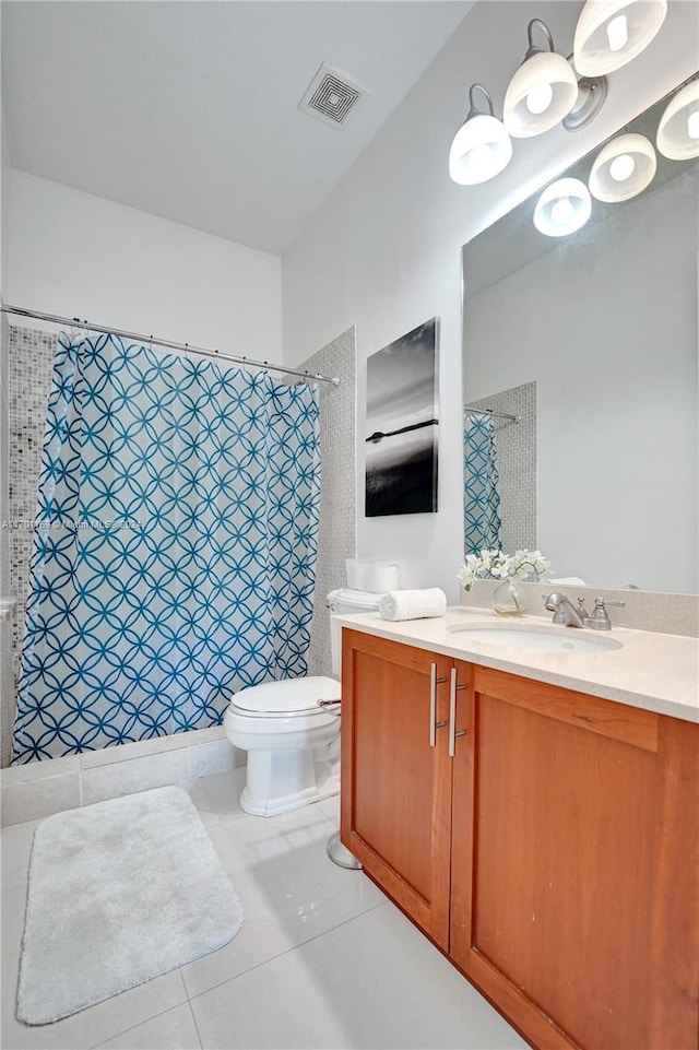 bathroom with toilet, a shower with curtain, vanity, and tile patterned floors