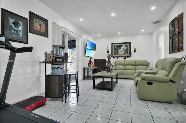 living room featuring a textured ceiling and light tile patterned flooring