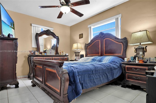 tiled bedroom featuring ceiling fan