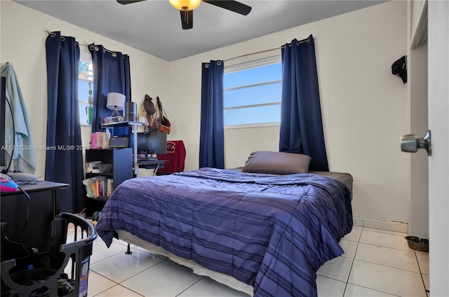 tiled bedroom featuring ceiling fan