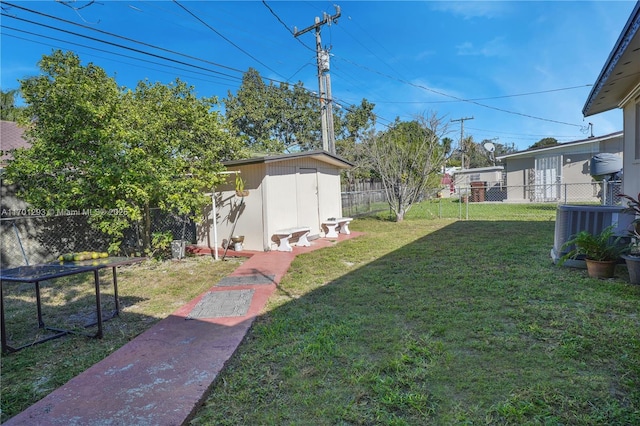 view of yard with cooling unit and a storage unit