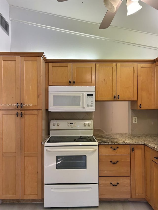 kitchen with white appliances, ceiling fan, and stone countertops