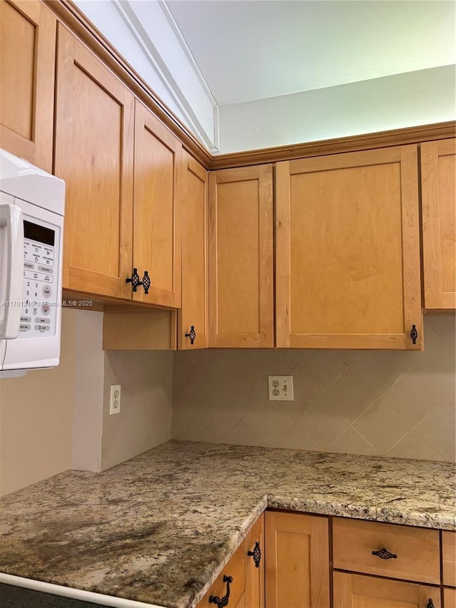 kitchen featuring light stone counters and decorative backsplash