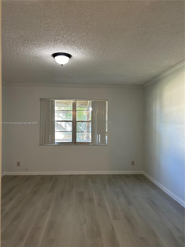 unfurnished room featuring crown molding, wood-type flooring, and a textured ceiling