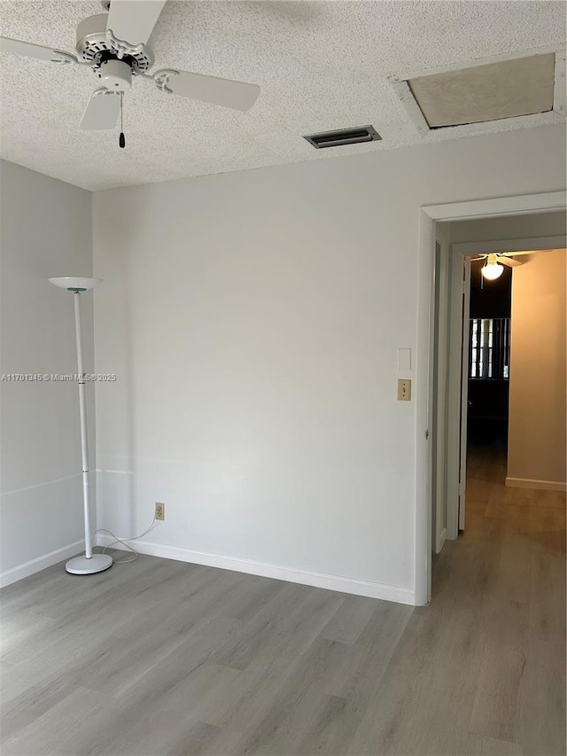 spare room with wood-type flooring and a textured ceiling