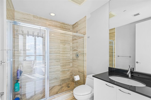 bathroom featuring walk in shower, vanity, wood-type flooring, and toilet