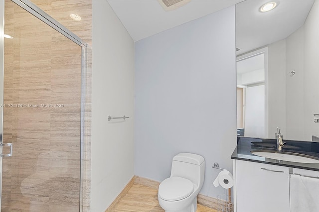 bathroom with wood-type flooring, lofted ceiling, toilet, a shower with door, and vanity