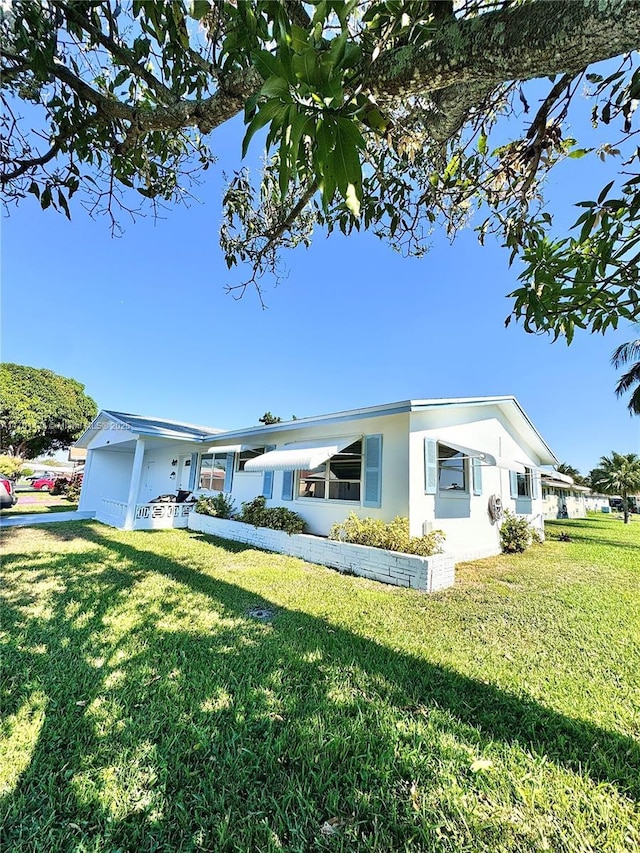 view of front of home with a garage and a front yard