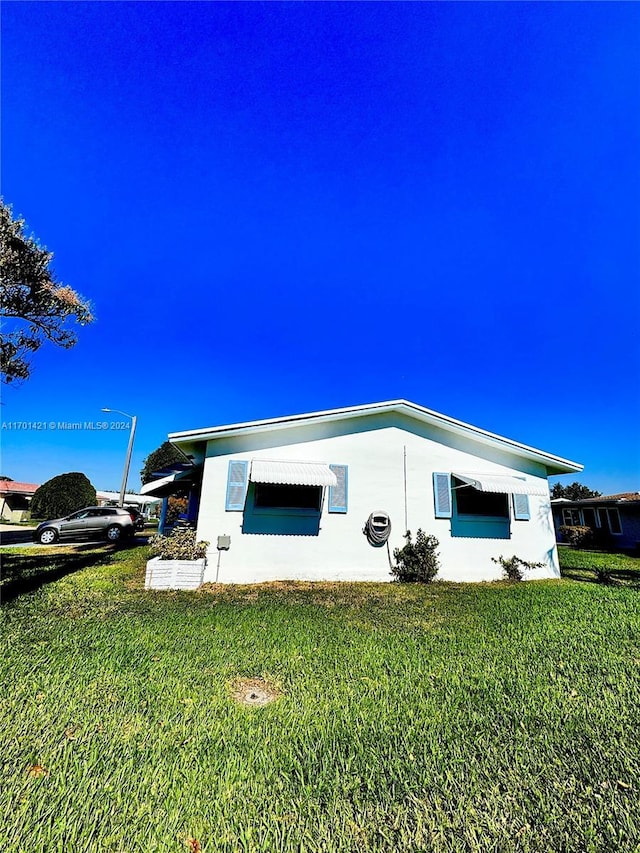 view of side of property with a yard