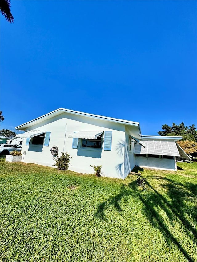 view of property exterior with a yard