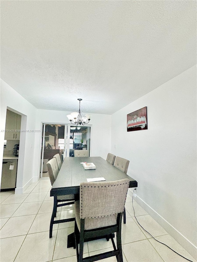 dining area featuring a notable chandelier, a textured ceiling, and light tile patterned flooring