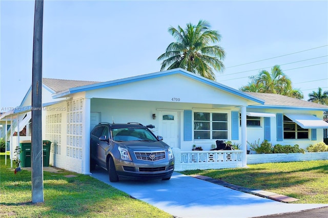 ranch-style home with a carport and a front yard