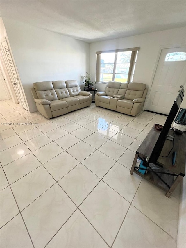 unfurnished living room with light tile patterned floors