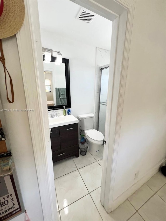 bathroom with vanity, toilet, and tile patterned flooring