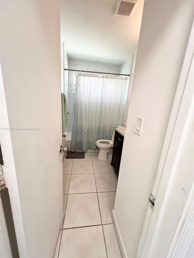 full bathroom featuring vanity, shower / bath combo, tile patterned floors, and toilet