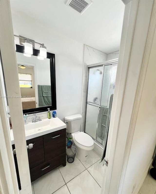 bathroom with vanity, an enclosed shower, and toilet