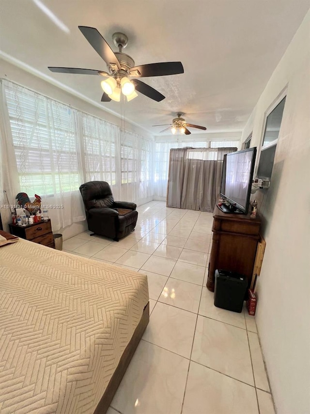 tiled bedroom featuring multiple windows and ceiling fan