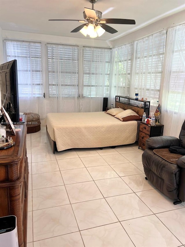 tiled bedroom featuring ceiling fan