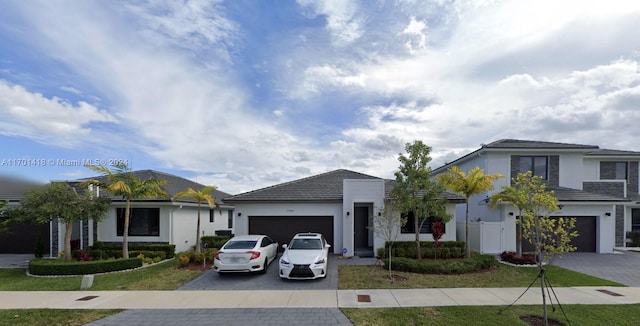 view of front of property featuring a front yard and a garage