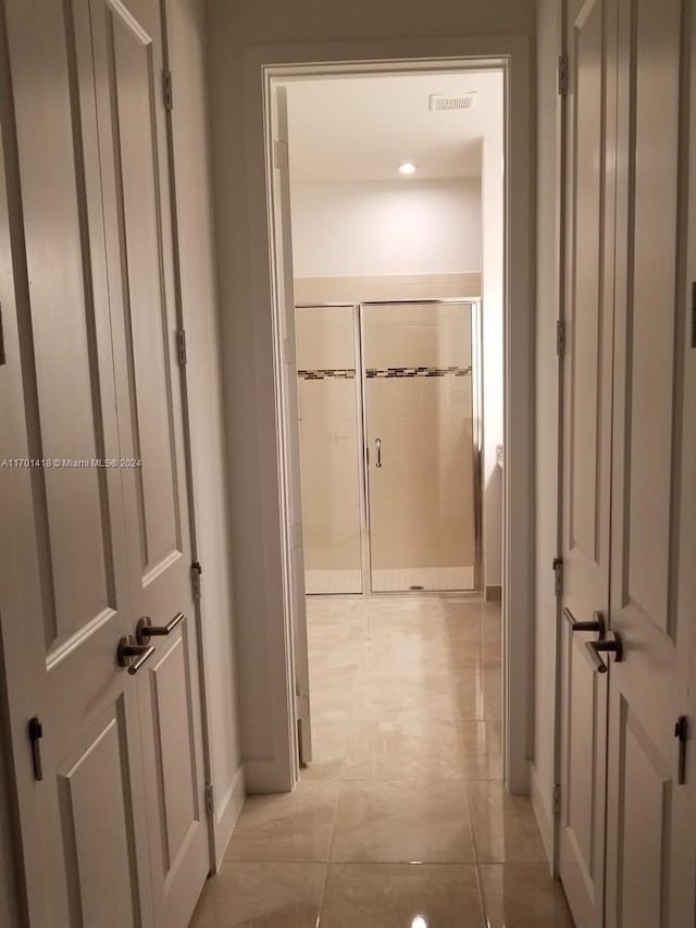 hallway featuring light tile patterned floors