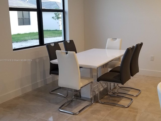 dining space with tile patterned flooring