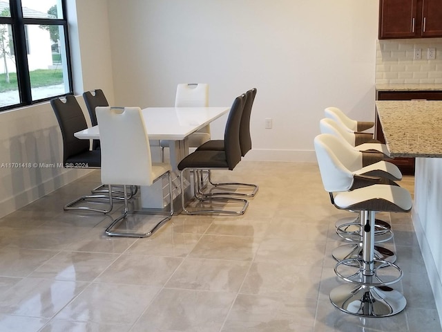 dining room with light tile patterned flooring