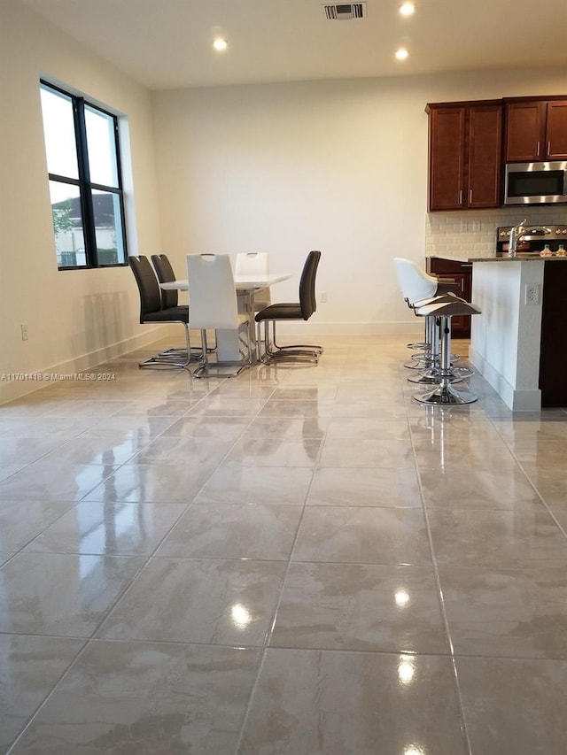 dining space with light tile patterned flooring