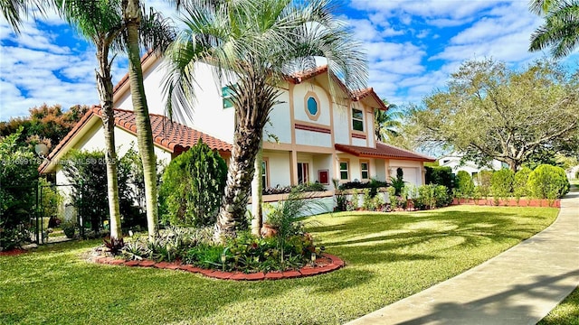 mediterranean / spanish house featuring a front yard