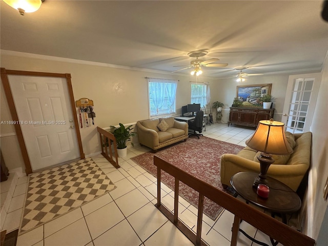 tiled living room with ceiling fan and ornamental molding