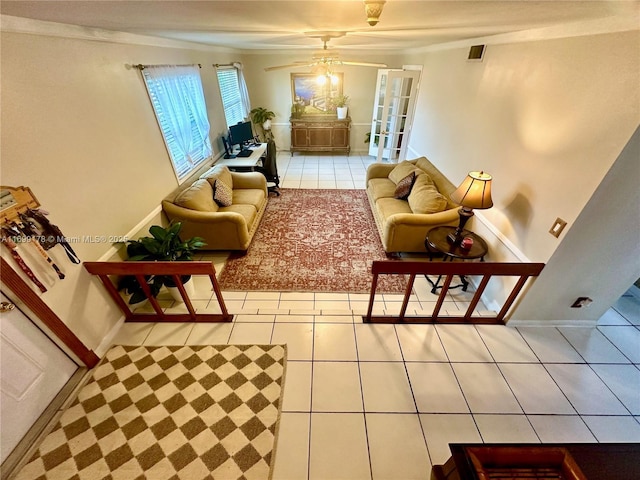 tiled living room featuring ceiling fan, french doors, and ornamental molding