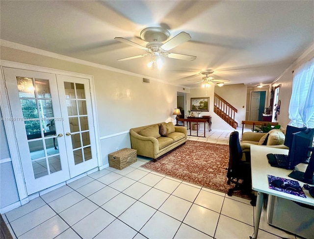 living room featuring ceiling fan, light tile patterned floors, ornamental molding, and french doors