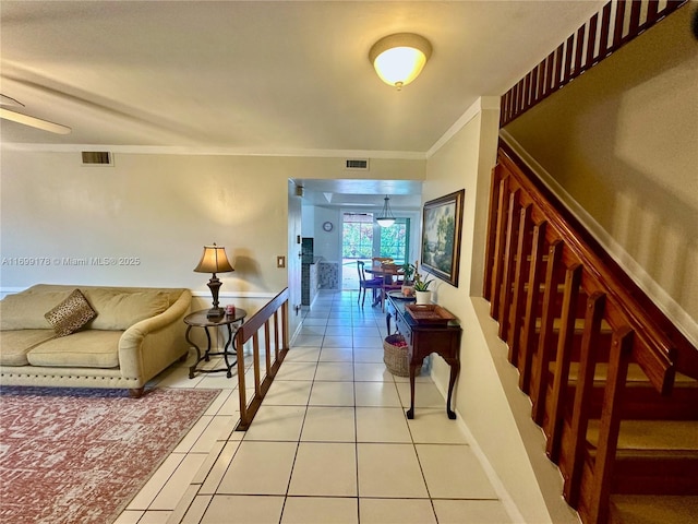 living room with ceiling fan, light tile patterned floors, and crown molding