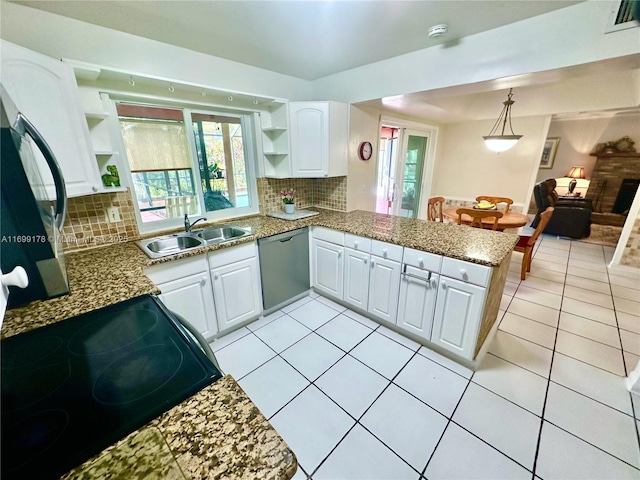 kitchen with dishwasher, white cabinets, sink, decorative backsplash, and kitchen peninsula