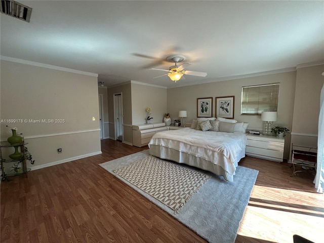 bedroom with dark hardwood / wood-style flooring, ceiling fan, and crown molding