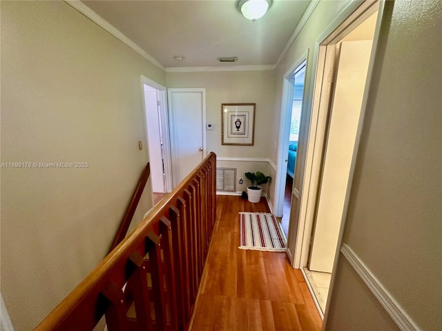 hall with crown molding and hardwood / wood-style floors