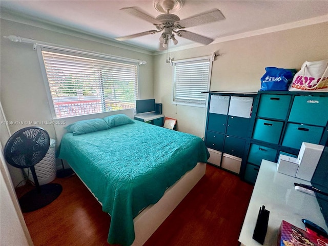 bedroom featuring ceiling fan, dark hardwood / wood-style floors, and crown molding