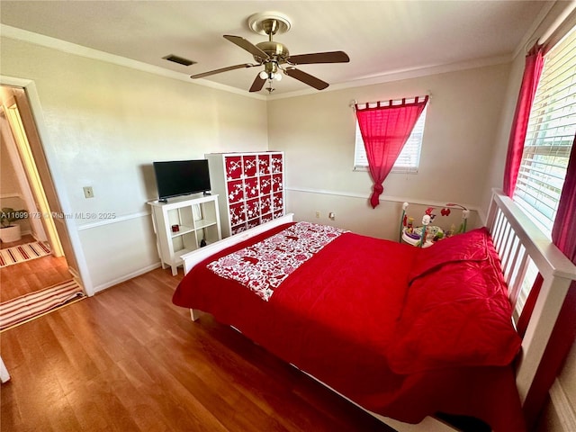 bedroom featuring ceiling fan, wood-type flooring, and ornamental molding