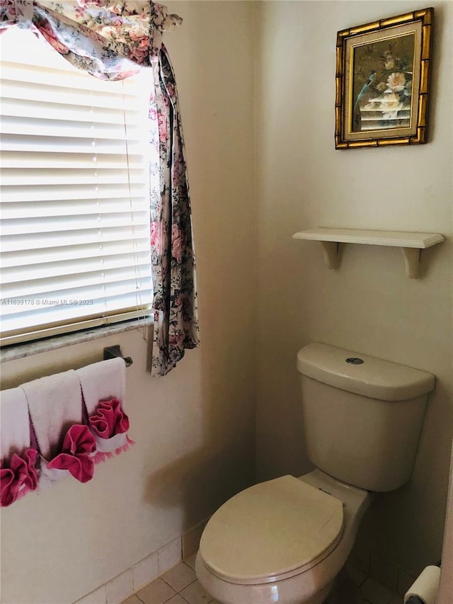 bathroom with tile patterned floors and toilet