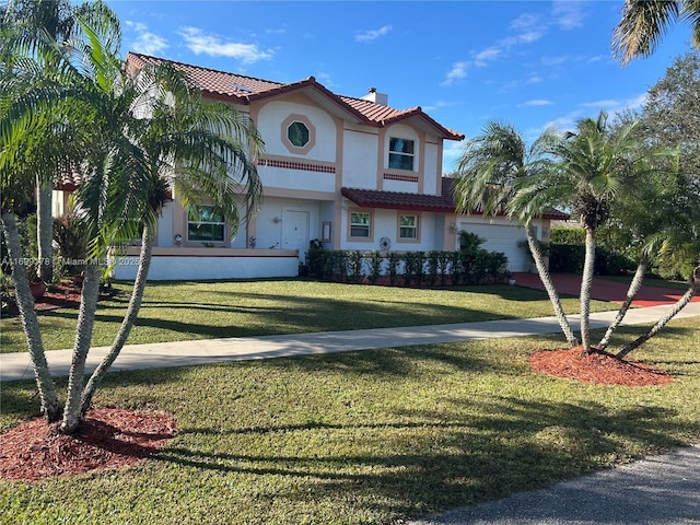 mediterranean / spanish home featuring a front yard