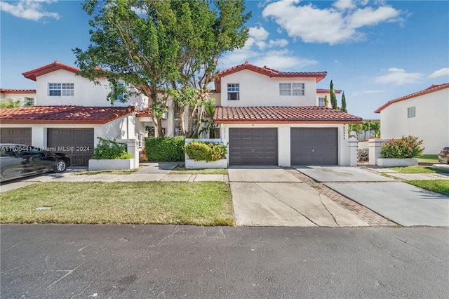 mediterranean / spanish home featuring a garage