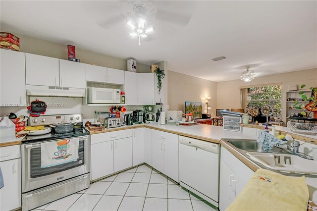 kitchen featuring white appliances, white cabinets, ceiling fan, light tile patterned floors, and kitchen peninsula