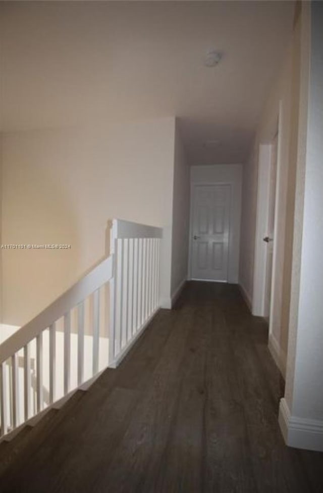 hall with dark wood-type flooring