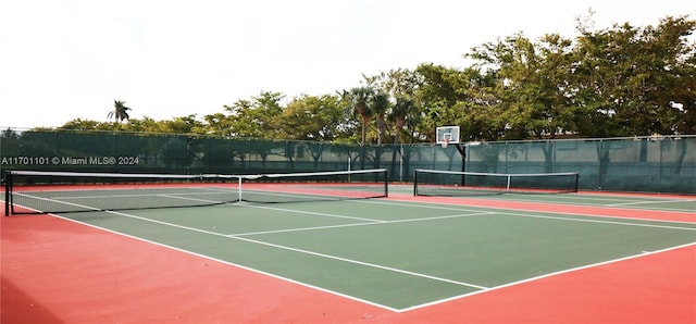 view of tennis court with basketball hoop