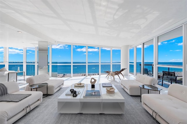 sunroom featuring a water view